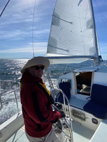 A person standing next to a boat  Description automatically generated