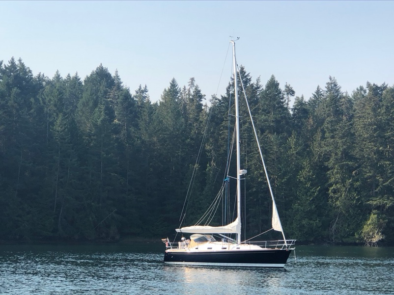 A small boat in a large body of water  Description automatically generated