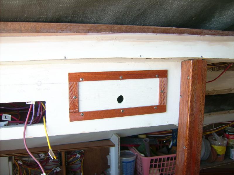 15 September 2012.  Here is the overhead locker above the quarter berth with the first of the trimmed lift-out panels installed.  All of this has to come apart again for finish paint; this is just the first one I did.  I have to have a system for getting all these bits of trim cut straight and installed square.

Notice the finger hole is at the bottom.  They're all like that-- because you lift it UP to tug the bottom edge out to remove it.