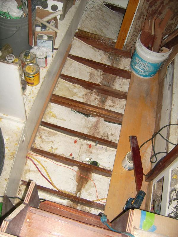 9 March 2012.  Bilge of Diana (did you know Hunter 25s have a bilge?).  These joists are all 5/4 mahogany, well-saturated in epoxy.  None of them touch the actual bottom of the hull-- they are all spanned from side to side along the garboard.  The forward one is doubled and supports the compression post.  The middle one has cleats fore and aft, meant to support the table leg and the forward and after lift-out panels.  The starboard side sole is installed-- this was just before I installed the other side.

The piece atop the paint can that looks like 2/3 of a joist goes in the head compartment (top of pic).

The awful yellow-brown stuff is spilled/dribbled/extra epoxy.  The large patch at the aft end is a 'glass patch over old drainage holes.  This will all be painted in Bilgekote.