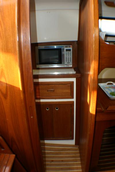 Added a stainless steel built in microwave to the quarter-berth.