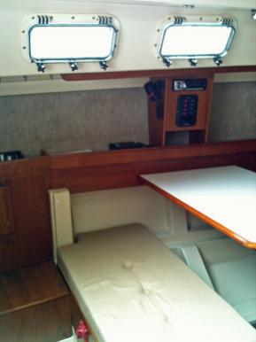 As long as I was fabricating a new top for the aft bench seat I did away with seatback.  The original seatback crowded the companionway ladder and hindered access to the double berth (sail locker) under the cockpit.  So far the seatback has not been missed, but then we never convert the table to a berth.