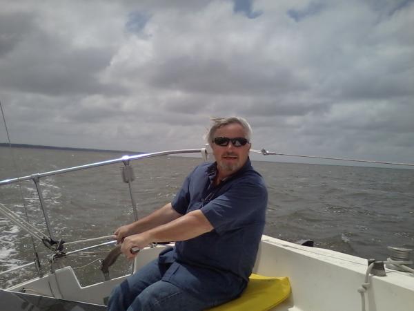 At the helm enjoying the day.