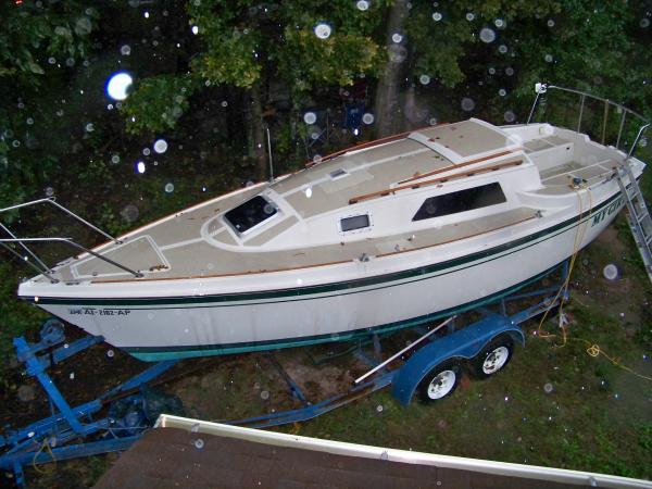 backyard sailor in word and deed. My Girl from my roof. A good view of her lines, new ports, front hatch, and trailor. In the rain