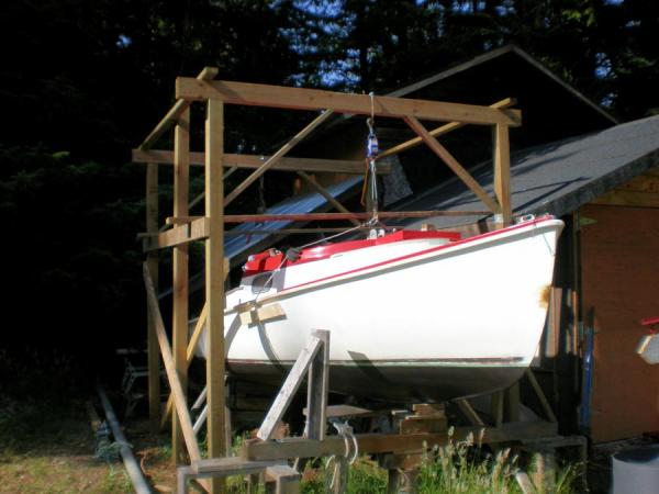 boat lift pictures. First test of boat in suspension. The planks near the comealong handles are loose and can be moved around as scaffolding during the lifting process.