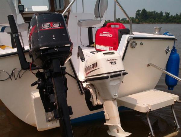 Boat Pictures 030 - The used Mercury 10 was quiet and reliable and got 10 mpg. Kept the new Johnson 15 for for next boat. After adding a nice built in bow sprit and swim platform, the Aquarius 23 became an Aquarius 27. Large cabin for a small boat. Reminded me of a fat, happy pig.