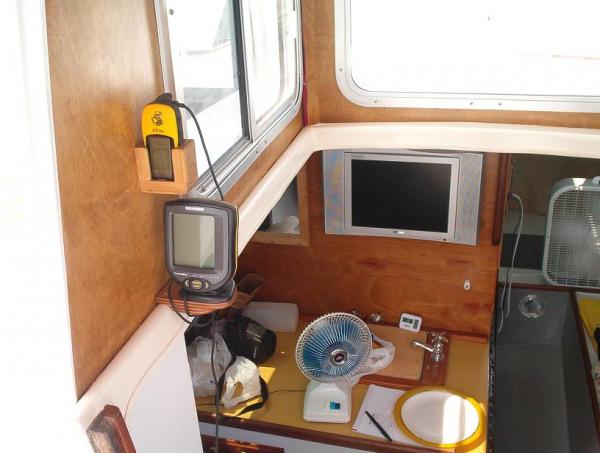 Boat Pictures 034 - Kept the tiller but could steer from many positions including inside the cabin during bad weather where I enjoyed watching court TV while going down the river. Hard to beat the cheapest little Garmin Etrek GPS and small Hummingbird depth finder, each about $89.