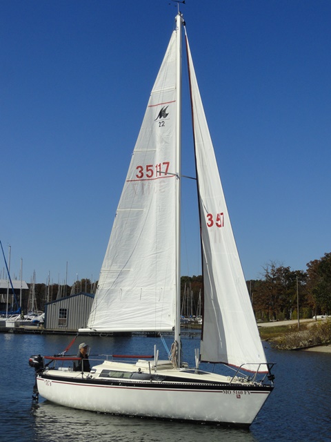 Calm day, posing for pictures. Airing out my new sail logo. The former owner invested in racing sails. I love them.