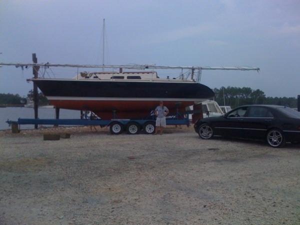 Caroline  in front of The Caroline Rose on the Trailer that I have for sale. The Boat is now 32'  since the addition of the Swim step platform she was white but, you got to love that Perfection paint in Flag Blue not the best picture...from my cell phone