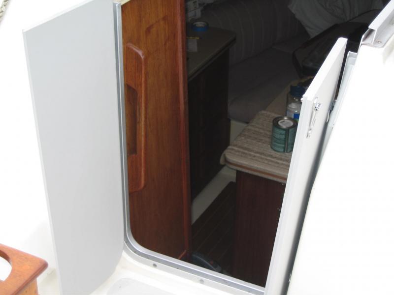 companionway doors - custom of starboard with half hinges and hasp.  can still use drop boards and custom screens.