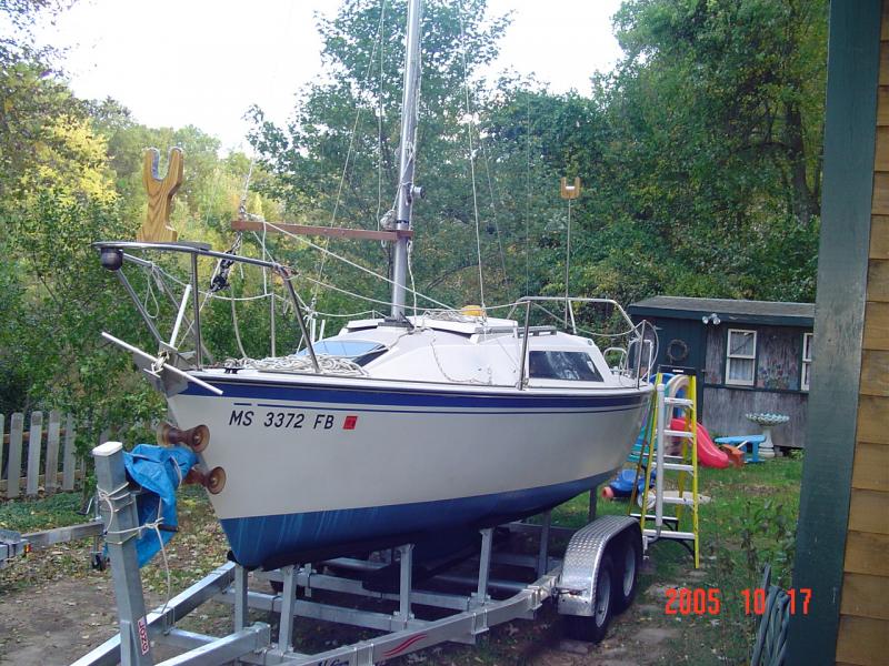 DSC00434 Here's a pic of my old Gin Pole.  Anyone can make one of these.  It doesn't have to come apart and you don't need to use stainless steel hardware.
The Gin pole provides the angle needed to raise your mast by using the Jib halyard and a boom vang or mainsheet blocks.
  You could also mount a small boat winch on the Gin pole and use that to pull your mast up.  
I have the yoke tied to the mast near the goose neck fitting and the end of my Gin Pole is about 1&quot; to 2&quot; from my forestay when the mast is up.  If the Gin Pole is too short, the boom vang will have a tendency to pull the yoke out of the mast once the mast is up.
If you set the Gin Pole too low on the mast, the Gin Pole will be too long and you'll have trouble reaching the end of the pole to snap your bridles in when the mast is laying horizontal and ready to be raised.   For this reason I chose to set my Gin Pole so that the yoke is near the goose neck fitting. 

Note how close the blocks of the boom vang are in this picture.  Before I inverted the line locking cam on the pulling block, I used to extend the boom with a wire tail piece that cam off my back stay that was connected to that triangular plate.   By inverting the cam on the block, I was able to do away with the tail piece and be able to connect the block to a shackle on my bow stem chainplate.  This gave me more space for my blocks.   The is another reason why the Gin Pole needs to be set near the goose neck fitting.  If you decide to use a boat winch to pull your mast up, you could mount the Gin Pole lower but the lower the Gin Pole on the mast, the longer it has to be.