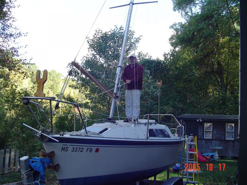 DSC00435 Note where I am standing as I am letting the mast down.   I want to be situated where I can grab hold of the mast if something goes haywire.   The boom vang allows me to do just that.   I'm not sure if the boat winch would allow this type of freedom.