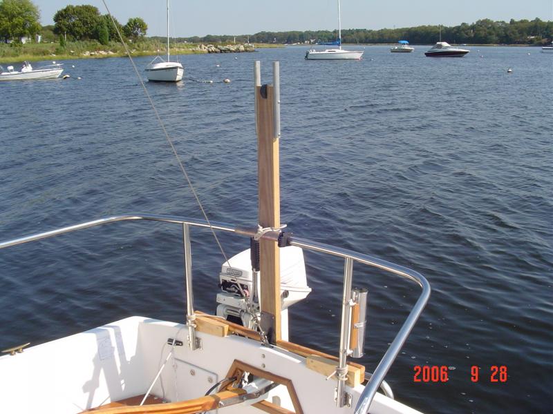 DSC00628 The stern rail as mentioned previously is very helpful for supporting the mast crutch.  I favor this mast crutch set up because it allows you to mount your rudder on the stern at the ramp and launch your boat if you choose to raise your mast with the boat sitting at the dock.

Having a roller inside the crutch allows you to roll the mast aft or forward instead of having to man handle it as I was doing for many years.