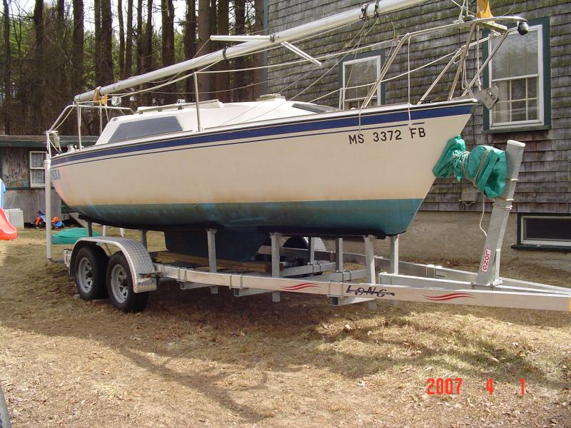 DSC00741 Here's what she looks like sitting on the trailer.  I think the tongue weight is about 110 lbs.
When I first bought the boat trailer, I brought it home and installed the sandwiched planks.   Then I took two of my SB-3 Brownell's Boatyard stands with me, along with my bathroom scale.  I had two jacks in my pickup truck to uses also.
I don't think I even bothered messing with the two short bunks under the bow until I got my boat home on this trailer.  The main bunks are the important ones that need to be set up.  The bunks under the bow could be set up later on after I had the boat on the trailer.