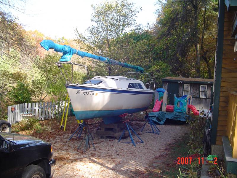 DSC00923 At the end of the boating season I always strip my mast of the standing rigging.   Everything including my CDI Roller Furler get stowed down my cellar.   I hang the furler up high on a long beam down there.  The rigging is all roller up and hung.  Halyards are left on the mast all done up.
The mast is wrapped with long pieces of short width old polytarp for chafe protection for my main 18'x30' Polytarp.