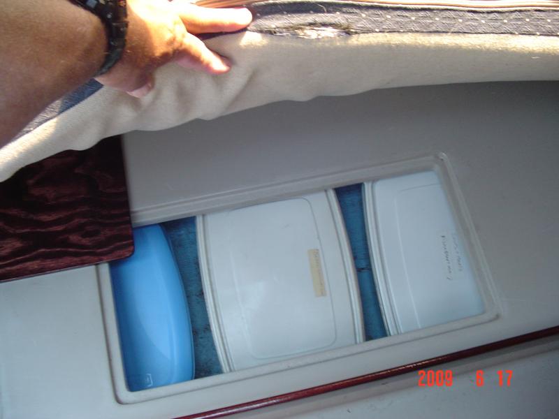 DSC01384  This pic shows my port quarter birth compartment.  I keep all my can goods, and other food items in these 2.5 gal. plastic containers.  I have three compartments on each side of the boat and in order to get at the two on each side that I use the most, I need to raise the mattress on that side and hold it with my head while I take the containers out of the compartment, which gets is to be a pain in the butt.  
I want to recover these mattresses with new material as soon as I can find some material that I like, cheap. 

 My latest brain storm is to cut these mattress foams in half which will make it a lot easer to move out of the way to get at each of the two compartments on both sides of the boat.  I can keep them joined with Velcro, as I have omitted the mattress under the cockpit on my boat.  This is an idea that I've been kicking around for a while and I think it's doable.