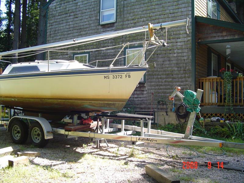 DSC01465 It's a slow process, I know, but it's the best way I know of doing this right now.  

A faster way and easier way to do this would be to support the bow with a long metal eye beam supported high enough to allow the trailer to be rolled right out from under the boat.   I would shore up under the keel just as soon as it's clear of the back of the trailer.  Then the beam could be removed. Two of the stands can also be move toward the bow of the boat about 6' or 8' from the other two stands on the stern.  The keel of this boat can take the full weight of the boat while sitting on blocks with at least two stands to keep it from tipping.  Two sailboat stands can be placed temporarily under the stern of the boat to keep it from tipping.  Preferably, the more stands the better.   I use four sailboat stands and one powerboat stand under the bow of the boat with the keel sitting on blocks.
The boat needs to be level at all times when you raise/lower the hull with stands and the jack.   Five of my stands can raise my boat with no problem.
Is this dangerous?  You bet it is.  I take every precaution when I do it.