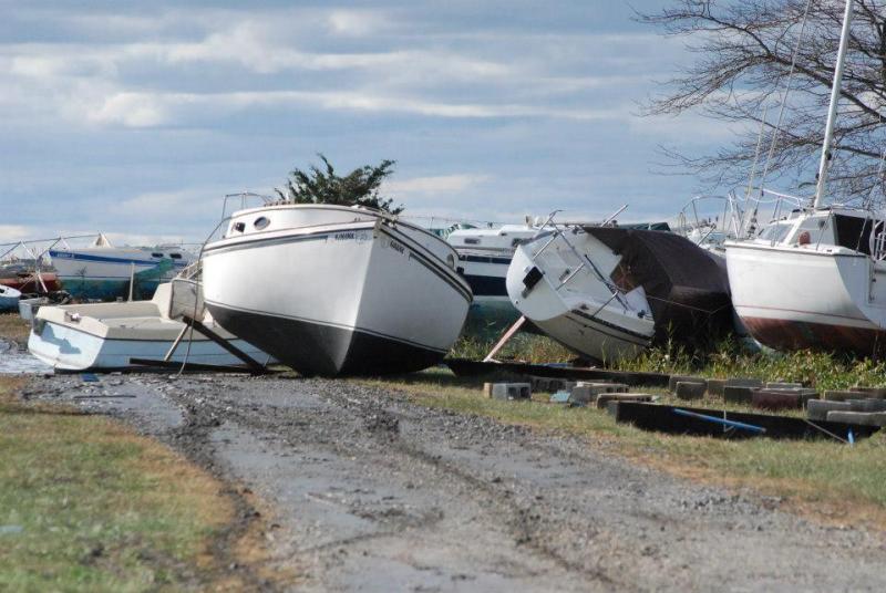 Flipped over on her side after being washed off jacks by Sandy and pulled out of the marshes