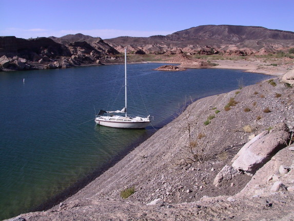 Floating, but tied to shore. Just climb off the bow.