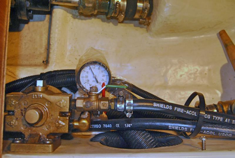 Fuel line vacuum gauge sensing fuel pressure downstream of the first (primary) filter.