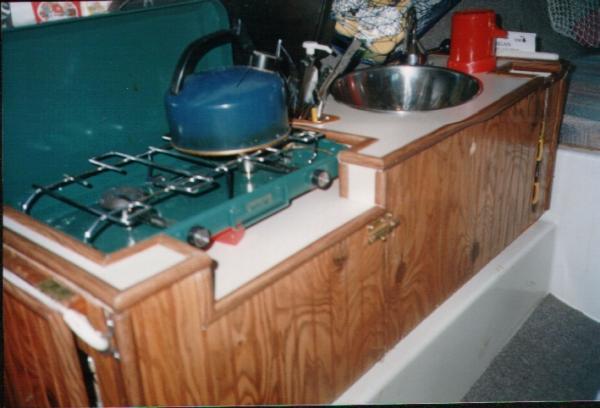 galley -- I made this years ago and it served us well.  Note the pump thermos that we fill with very hot water in the morning so we have water for coffee, tea, or soup all day long.  Also note the slotted cup rack.