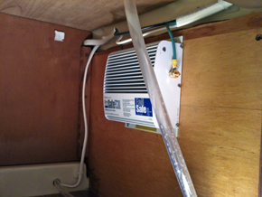 Galvanic isolator in cabinet in galley.  (The clear tube in the foreground is the fresh water line to the galley sink.)