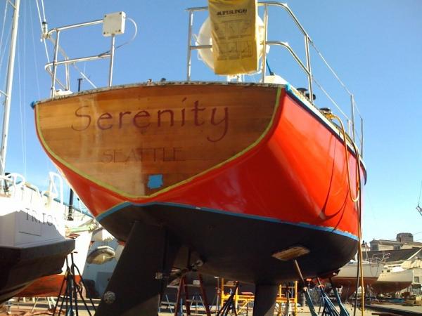 Her new name after laying her up to replace some rotten floor timbers. Step 1: don't bore holes through wooden timbers to run your water lines. Step 2: otherwise it costs 8K to cut them out and replace/re-glass them. Step 3: varnishing the transom is a pain in the butt.