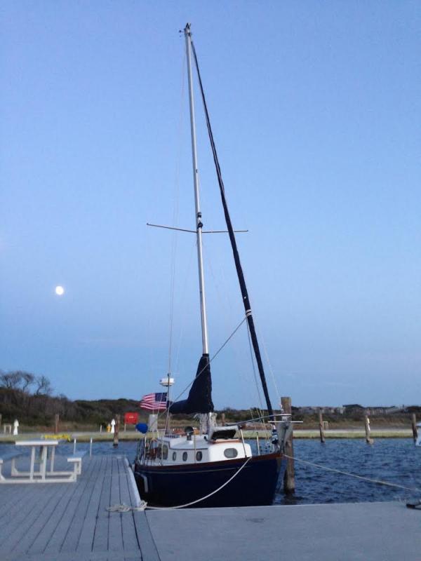 Here is a photo of Andy's Rhodes-designed Swiftsure 32 Sinter Klaas, moored at Watch Hill, which he proudly sent me to convey his joy at having his beloved boat back after we repaired/restored it.

This boat was built by DeVries-Lentsch in Holland in 1959.  As part of being repaired after Storm Sandy, it received new teak toerails, 34 ft long each with compound angles made by Steve and Ziggy cranking the blade tilt on the tablesaw while pushing/pulling the wood through it.  Jeremiah faired the hull and sprayed it in Awlgrip.  Lee and I reengineered the fuel tank, batteries, gas-bottle locker, air conditioner and plumbing to redistribute weight lower and farther forward.  We also replaced the original 1959 seacocks with new Marelon ones.  Ziggy made a new 'fridge lid as a chart table and made a new galley counter.  The whole deck was repainted and new bronze hardware installed, including a Dutch-made traveler.  Lee ordered a Selden rig (not my favorite as it's too fat for the boat).  Dave ordered him a new Lewmar winch for the spar but missed out on getting the last-available Lewmar 30 in bronze, which is what it should have had.  And we removed and replaced the Atomic Four engine, which Andy loves (with good reason; it's a lovely old-school motor).

I rebuilt the rudder with foam and massive amounts of 'glass, and then in the course of removing and replacing the engine I replumbed and repainted his heat exchanger, which Andy thought pretty cool.  I also designed and ordered a new bow pulpit and completely redesigned the stern end, doing away with the toerail there because, as I told Andy, that part of a boat is like the cute girl's bottom in a bikini-- everyone wants to see that part, stare at it, and become mesmerized by it.  This boat's backside is too pretty to cover over with a toerail. Andy agreed; and now you can see the lines of the boat much better all over.

Summer 2014