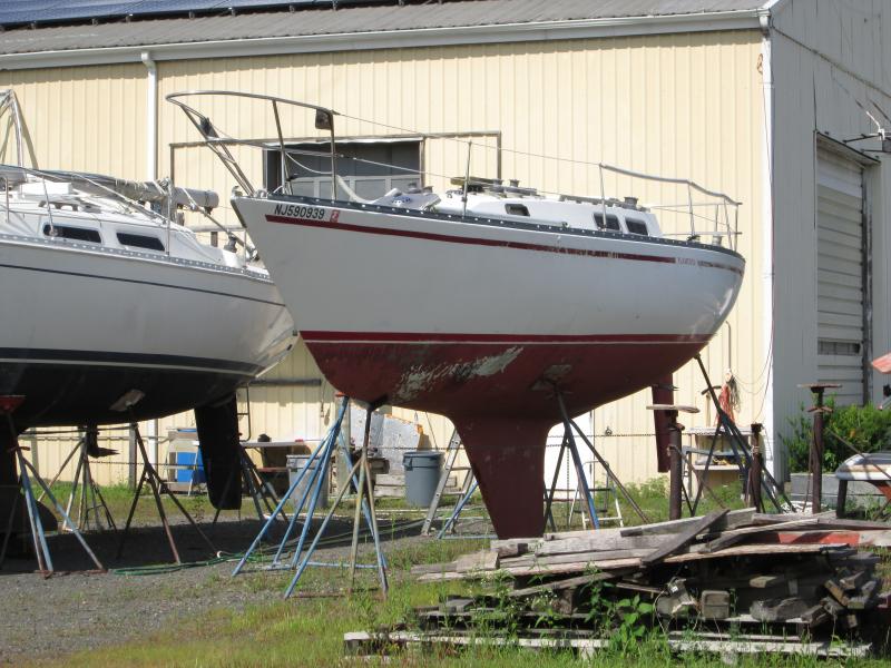 Here is Flamenco, Raider 33 no.2 (1976), having been damaged in Raritan Bay during Storm Sandy and bought as salvage after being totaled.  This boat has much less damage than either the other Raider (no.15) or the Swiftsure had but has more extensive 'old-boat' problems, such as soft decks.  I would very much like to have this boat myself; but I have no way of storing it and repairing it simultaneously.  It may be for sale-- if you're willing to have us redo it for you.

The very nice Hanse 31 beside it is for sale as well.  

Just look at the lines of this Raider.  If the C44 is the prettiest boat in the world, this one is a very close second.  In no place is there anything egregious or out-of-place.  Its beauty is sublimity itself.

4 Aug 2014
