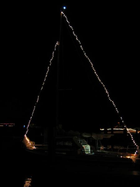 I love lights that don't take much power.  We pulled the string of lights up with the halyards, loosely attaching the string to the stays about every 18&quot;.