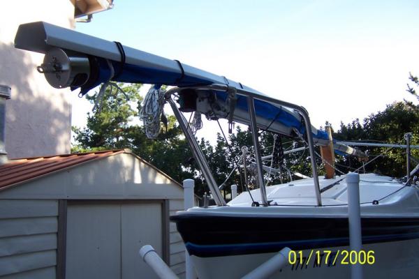 I use a PVC raingutter to provide support for CDI furler, fastened with ball bungies while trailering.  I put the gutter on top, so water will not be able to sit inside.
