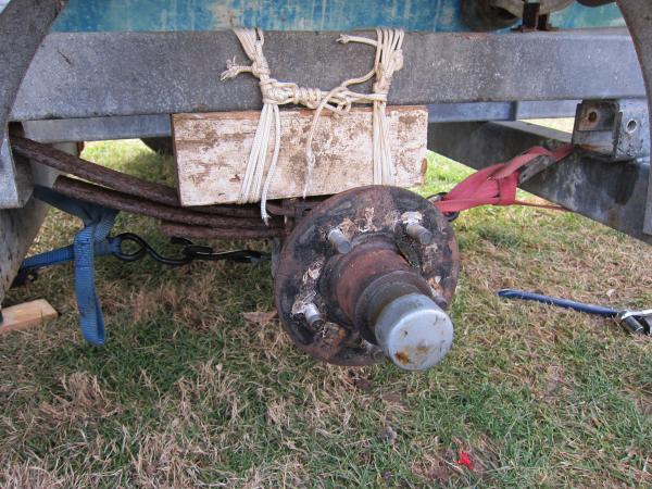 I won this boat on ebay.Noone seemed to realize the springs had broken until we tried to move her.The hull was full of water and might be why the springs gave way.I drilled a half inch hole in the transom and she drained for a long time.The previous owner thought I was nuts when the first thing I did was put a hole in the hull.This was how we improvised to get her on the road.It was a nervous and slow 230 mile trip home but we made it.