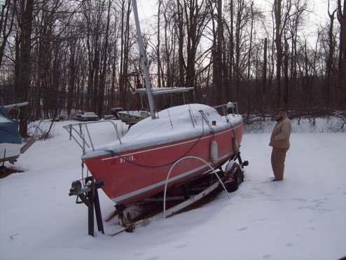 Initial Find.  Both tires flat and sunk in frozen soil.  The scuppers had clogged and cockpit filled with water.  The water overflowed into the cabin.  Cabin filled with water and FROZE.  What a terrible shame, for lack of minor maintenance thousands of dollars of potential damage.