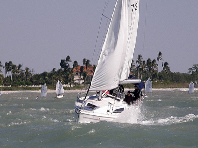 Island Dreams on a breezy day in the Gulf! Check out the Opti's in the background!