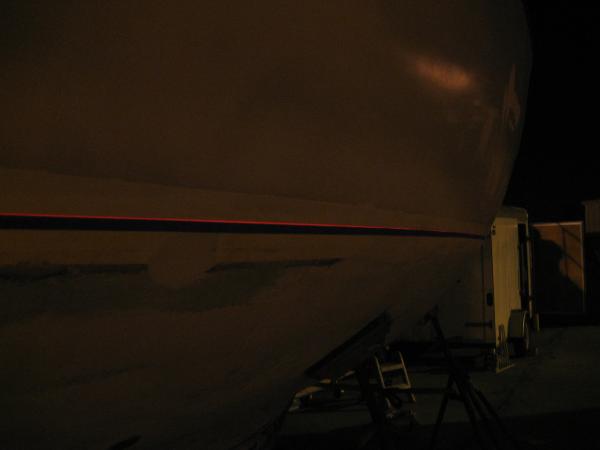 Its hard to see on this picture but after leveling the boat by working on the stands, I set up my construction laser and shot a line at night. I used the skum line as a reference point. The actual painted boot stripe was too low and barnacles had attached themselves to the boot stripe and left craters after removing them. I raised the stripe by 4 inches.