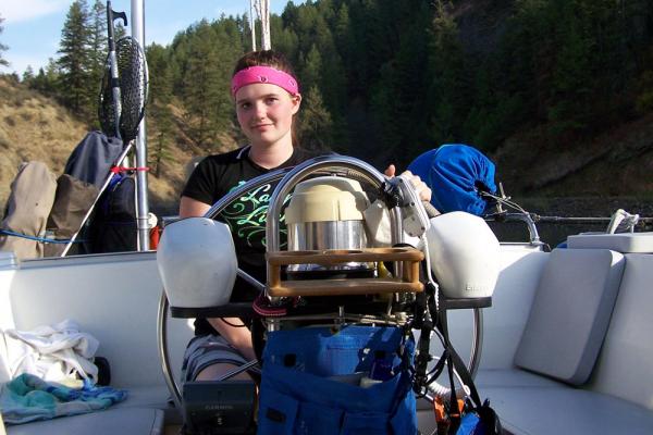 Ms. Clementine at the helm navigating Hawk Creek fjord, Lake Roosevelt, WA.