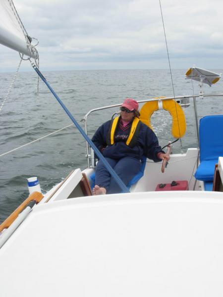 My wife Joan at helm on a chilly July morning.