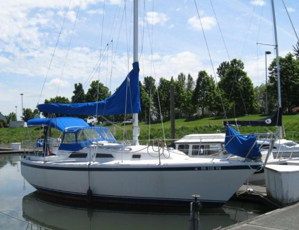 New custom canvas bimini with top window, attached dodger with full windows and handrails, and new custom mainsail cover from the Sail Loft.