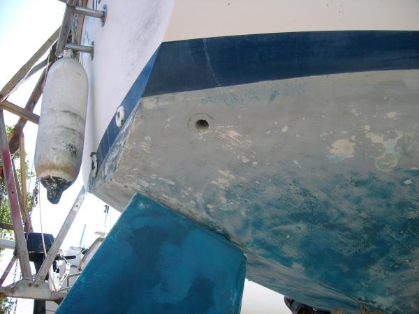 Note near abscence of bottompaint after 50 months in water. Starboard cockpit drain in foreground.