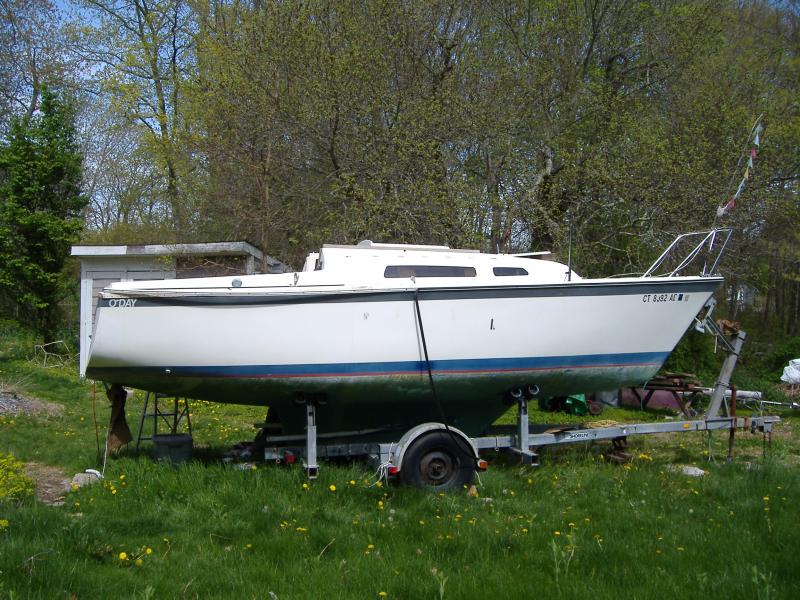 O'Day 23 - acquired Nov 2010. Water had seriously entered the cabin, baked under the hot sun for a few years, along with mice taking residence. Here I'm getting started, spring 2011, starboard aft rub rail unscrewed for stanchion repair.