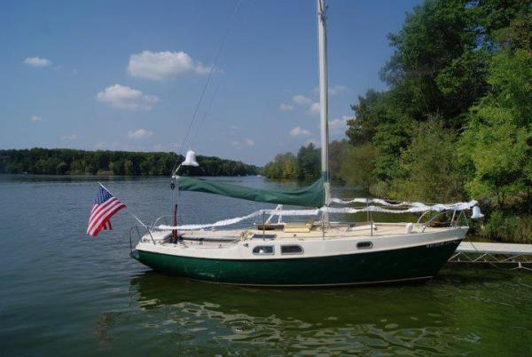 Our Pearson Lark.
I formed a rear step platform out of fiberglass that extended
the hull 18 inch's. It reduced the drag alot. Now the only wake behind the boat is just a little swirrel on top the water.
I also glassed in the outboard underneath because the hole provided for the motor was about a foot square and the water would scoop up into the motor compartment and cause alot of drag. Those 2 things made this boat sail much better and added speed. There's no gurgleing sound from the water slipping off the hull now, just silence.