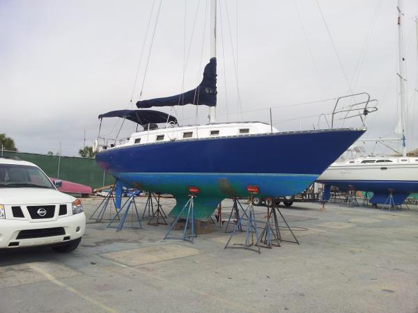 Out of the water and in the yard to get started on a refit.