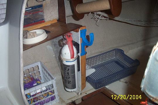 Portside stowage, paper towel holder (empty) and fire extinguisher. The was taken prior to stowing the usual gear for the season.