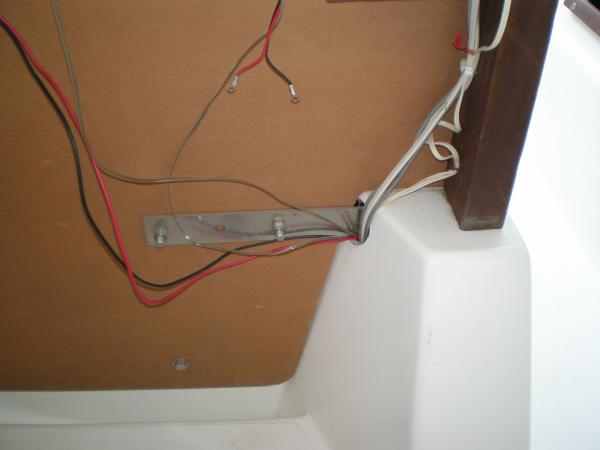 Rat nest of wires behind wall