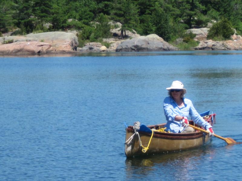 Rebecca paddling our nested solo canoes