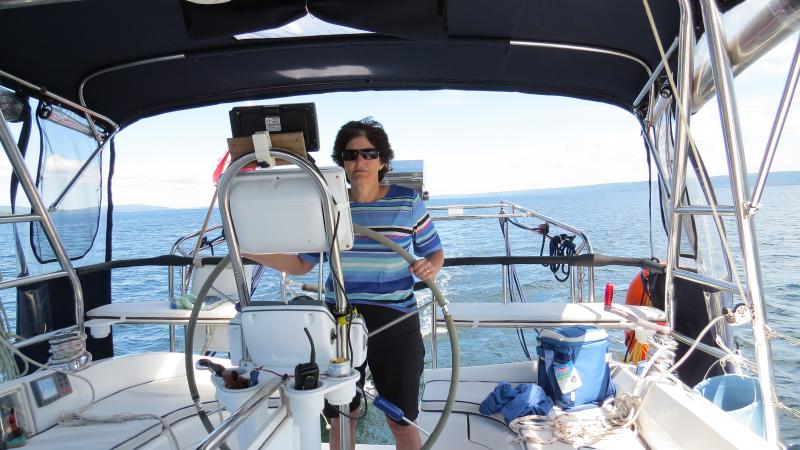 Rita in control on the Bras d'Or Lakes on the way to Baddeck.