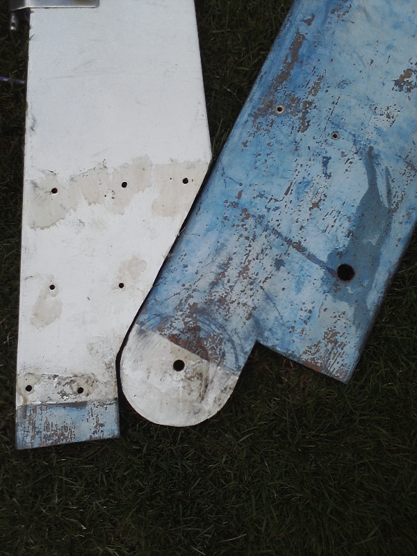 Rudder showing angle cut in top section, allowing the lower section to also angle more upward. I think a little safer traveling down the road. Seven small holes in top section to mount plates and one larger hole in lower section for the pivot bolt.