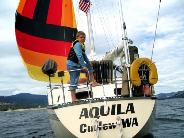 s/v AQUILA under the 'little' kite with grandson Kolten at the aft rail.