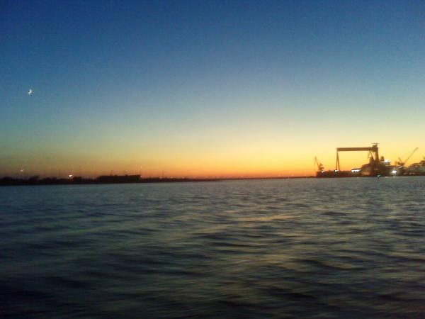 sailing in at dusk looking at the Goliath Crane at Northrup Grummen Ship Systems