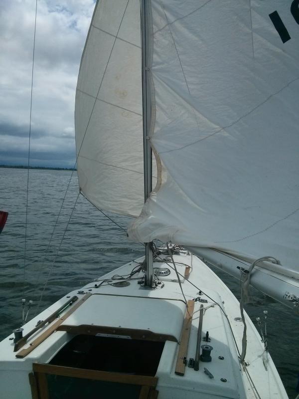 Sailing in inner bay near Long Point, Lake Erie,putting up the main sail